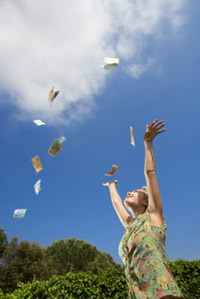 Woman throwing money in the air