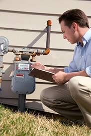 Man checking utility meter